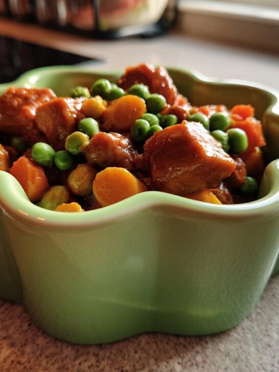 A close-up of a Chicken and Green Pea Bowl, featuring tender chicken pieces and vibrant green peas in a savory sauce.