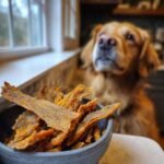 A bowl of homemade Chicken Turmeric Anti-Inflammation Jerky with a golden retriever dog in the background.